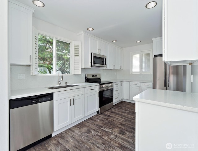 10105 6th Dr SE Unit B, Everett, WA 98208 - kitchen with stainless steel appliances, white cabinetry, dark wood-type flooring, light countertops, and recessed lighting