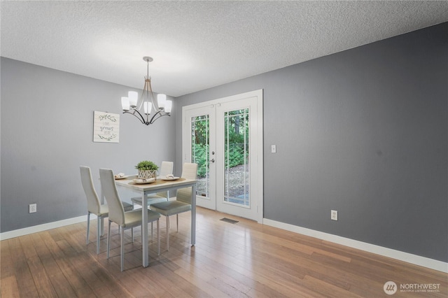 13719 Pinehurst Ln NW, Gig Harbor, WA 98329 - dining space with a chandelier, hardwood / wood-style flooring, and a textured ceiling