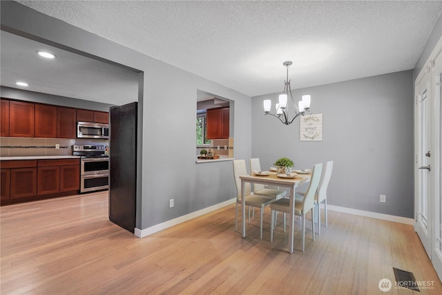 13719 Pinehurst Ln NW, Gig Harbor, WA 98329 - dining space featuring a chandelier, light wood-style flooring, recessed lighting, and a textured ceiling