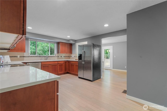 13719 Pinehurst Ln NW, Gig Harbor, WA 98329 - kitchen featuring appliances with stainless steel finishes, backsplash, light countertops, healthy amount of natural light, and recessed lighting