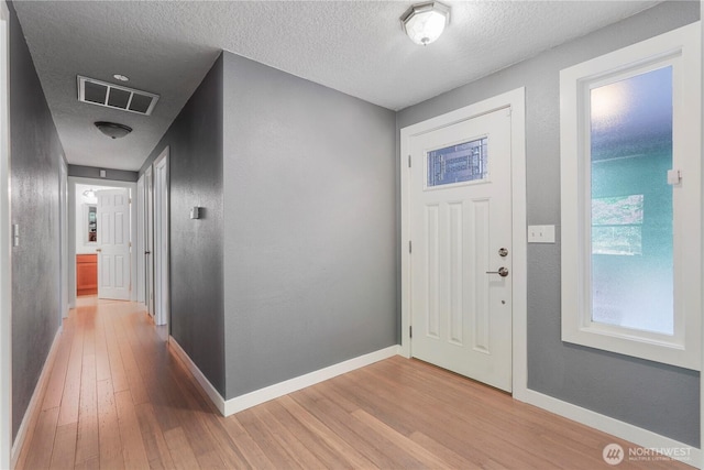 13719 Pinehurst Ln NW, Gig Harbor, WA 98329 - foyer featuring light wood-style flooring and a textured ceiling