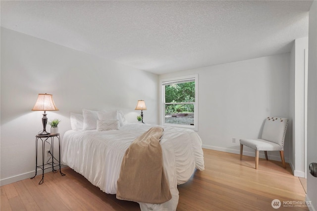 13719 Pinehurst Ln NW, Gig Harbor, WA 98329 - bedroom with wood finished floors and a textured ceiling