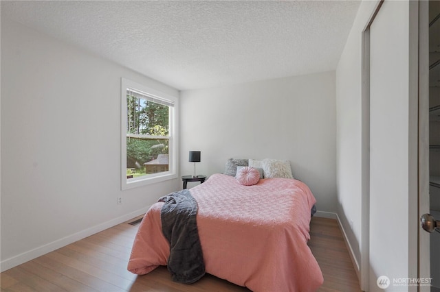 13719 Pinehurst Ln NW, Gig Harbor, WA 98329 - bedroom with wood finished floors and a textured ceiling