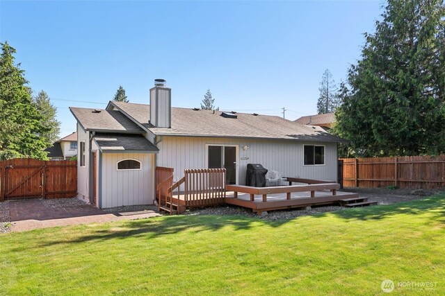21850 SE 271st Pl, Maple Valley, WA 98038 - back of house with a fenced backyard, a chimney, a deck, and a shingled roof