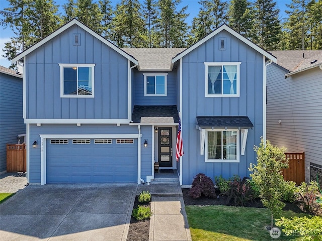 18740 130th St E, Bonney Lake, WA 98391 - view of front of house featuring board and batten siding, a shingled roof, concrete driveway, and an attached garage