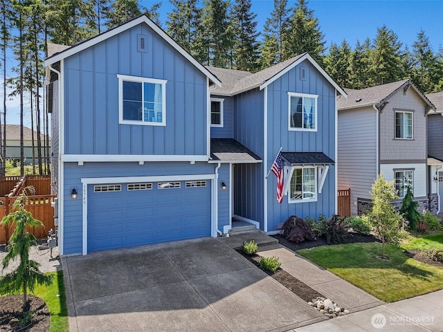 18740 130th St E, Bonney Lake, WA 98391 - view of front of house featuring board and batten siding, driveway, an attached garage, and a shingled roof