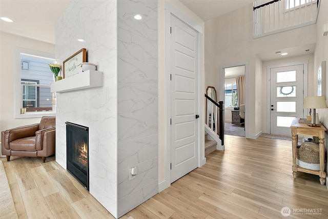 18740 130th St E, Bonney Lake, WA 98391 - entrance foyer featuring a premium fireplace, light wood-style flooring, and stairs
