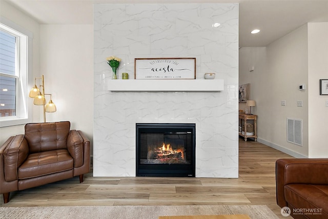 18740 130th St E, Bonney Lake, WA 98391 - living room featuring wood finished floors, a fireplace, and recessed lighting