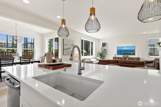 18740 130th St E, Bonney Lake, WA 98391 - kitchen with light countertops, pendant lighting, open floor plan, recessed lighting, and white cabinets