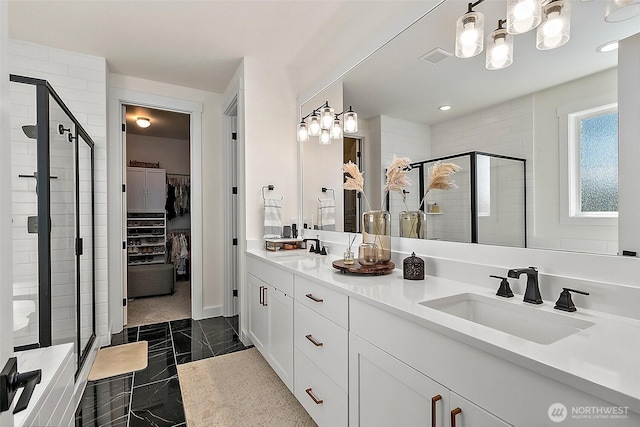 18740 130th St E, Bonney Lake, WA 98391 - bathroom with a stall shower, double vanity, a walk in closet, and marble finish floors