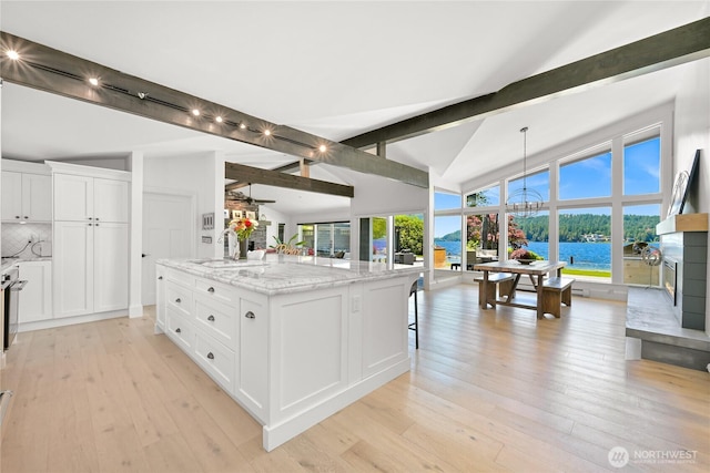 3231 Northshore Rd, Bellingham, WA 98226 - kitchen with open floor plan, light wood-style floors, white cabinets, tasteful backsplash, and a center island