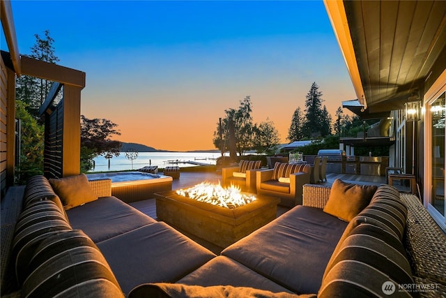 3231 Northshore Rd, Bellingham, WA 98226 - patio terrace at dusk featuring a water view and an outdoor living space with a fire pit