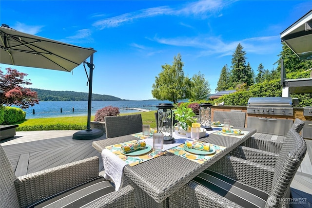 3231 Northshore Rd, Bellingham, WA 98226 - wooden terrace with outdoor dining area, exterior kitchen, and a water view