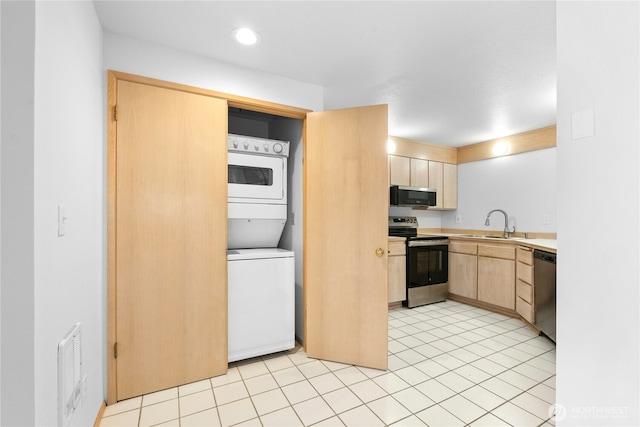 19528 Echo Lake Pl N Unit B202, Shoreline, WA 98133 - kitchen with appliances with stainless steel finishes, stacked washer / drying machine, light brown cabinetry, light countertops, and light tile patterned floors