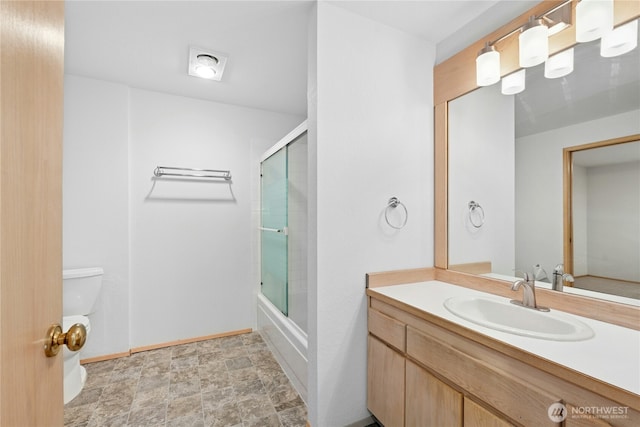 19528 Echo Lake Pl N Unit B202, Shoreline, WA 98133 - bathroom featuring vanity, bath / shower combo with glass door, and stone finish flooring