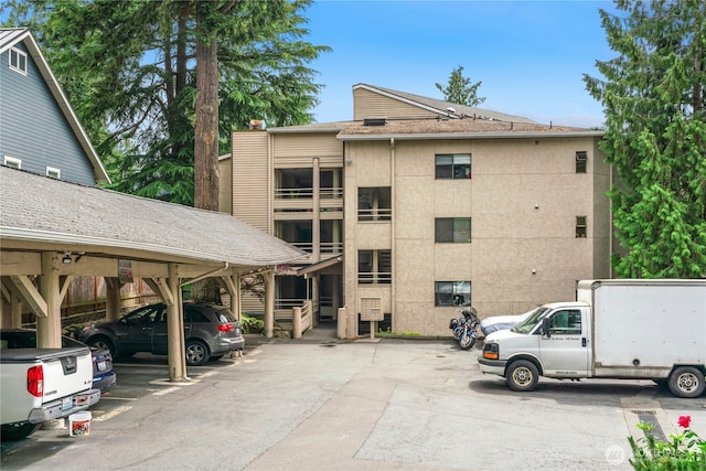 19528 Echo Lake Pl N Unit B202, Shoreline, WA 98133 - view of building exterior featuring covered and uncovered parking