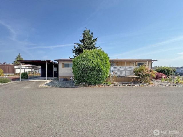 610 W Spruce St Unit 116, Sequim, WA 98382 - manufactured / mobile home with an attached carport and concrete driveway