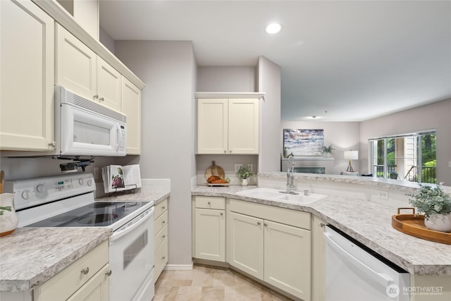2147 Hammond Ave Unit B10, Dupont, WA 98327 - kitchen featuring white appliances, light countertops, recessed lighting, and a peninsula