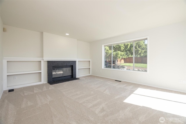 9825 S 246th Pl, Kent, WA 98030 - unfurnished living room with a brick fireplace, carpet floors, built in shelves, and recessed lighting