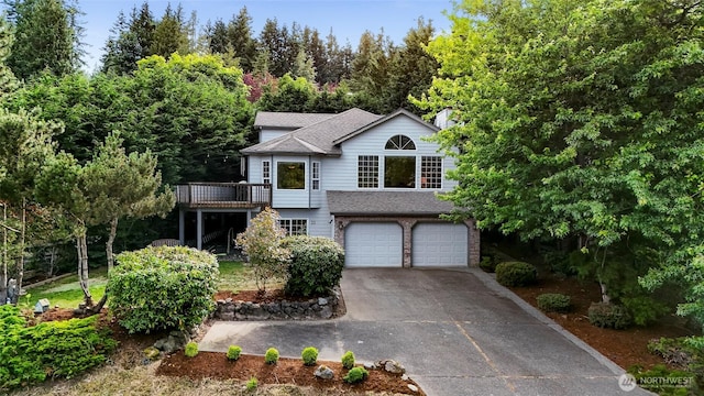 21 Longshore Ln, Bellingham, WA 98229 - view of front of property featuring concrete driveway, an attached garage, a deck, and roof with shingles