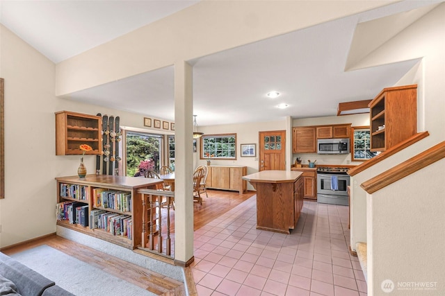 21 Longshore Ln, Bellingham, WA 98229 - kitchen with appliances with stainless steel finishes, open shelves, a kitchen island, light countertops, and brown cabinets