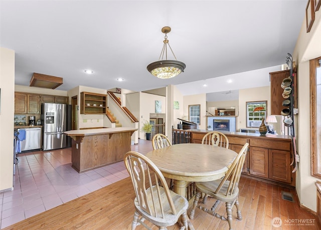 21 Longshore Ln, Bellingham, WA 98229 - tiled dining area with a fireplace, stairway, and recessed lighting