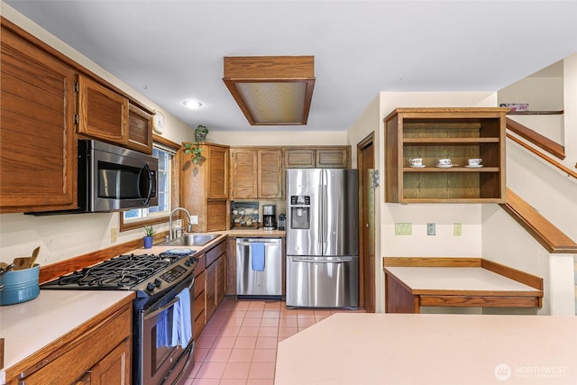 21 Longshore Ln, Bellingham, WA 98229 - kitchen featuring appliances with stainless steel finishes, light countertops, light tile patterned flooring, brown cabinetry, and open shelves