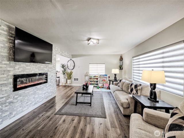 404 Nixon St S, Roy, WA 98580 - living room featuring wood finished floors, a fireplace, and a textured ceiling