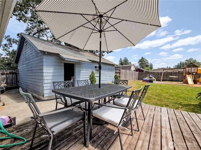404 Nixon St S, Roy, WA 98580 - wooden deck with outdoor dining area, a playground, and a fenced backyard