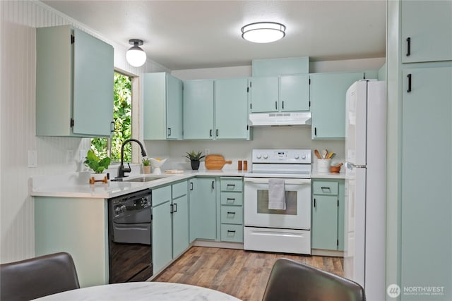1405 Canyon Ct, Port Orchard, WA 98366 - kitchen with white appliances, under cabinet range hood, light countertops, and light wood finished floors