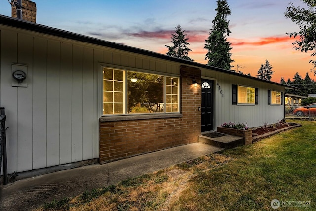 4801 78th St E, Tacoma, WA 98443 - view of front facade featuring a lawn, brick siding, and a chimney