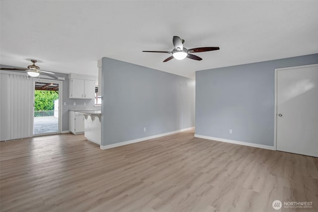 4801 78th St E, Tacoma, WA 98443 - unfurnished living room with a ceiling fan and light wood-type flooring