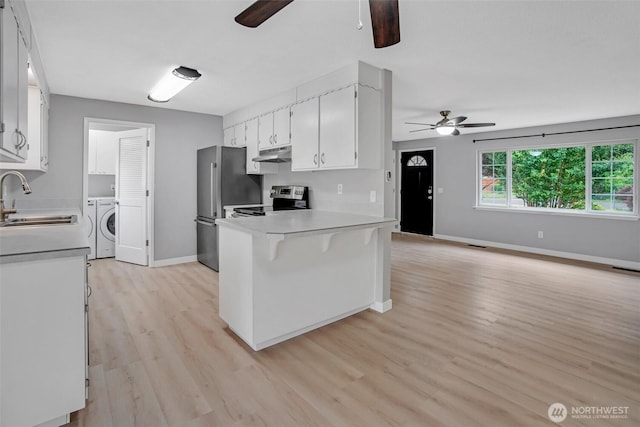4801 78th St E, Tacoma, WA 98443 - kitchen featuring ceiling fan, under cabinet range hood, washer / dryer, and light countertops