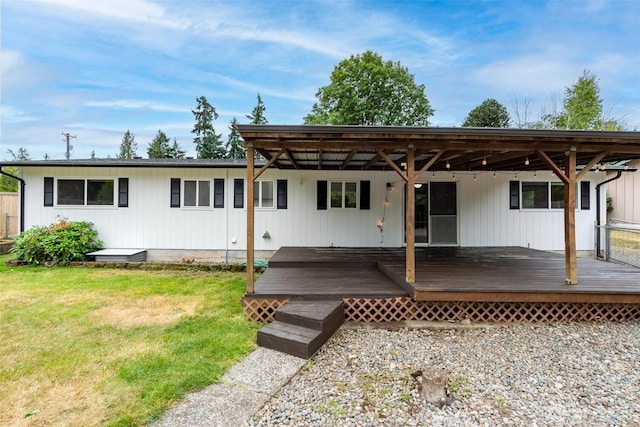 4801 78th St E, Tacoma, WA 98443 - rear view of house with a lawn and a deck