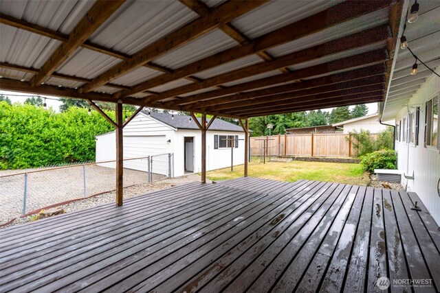 4801 78th St E, Tacoma, WA 98443 - deck featuring a fenced backyard, an outdoor structure, and a garage