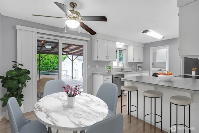 4801 78th St E, Tacoma, WA 98443 - dining space with washer / dryer, light wood-type flooring, and a ceiling fan