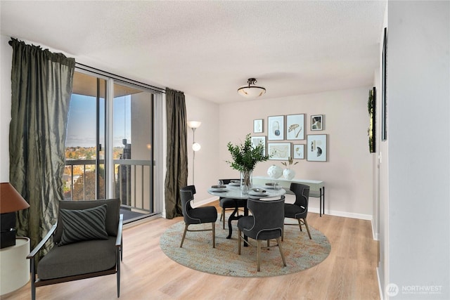 4540 8th Ave NE Unit 1102, Seattle, WA 98105 - dining area with light wood-style flooring and a textured ceiling