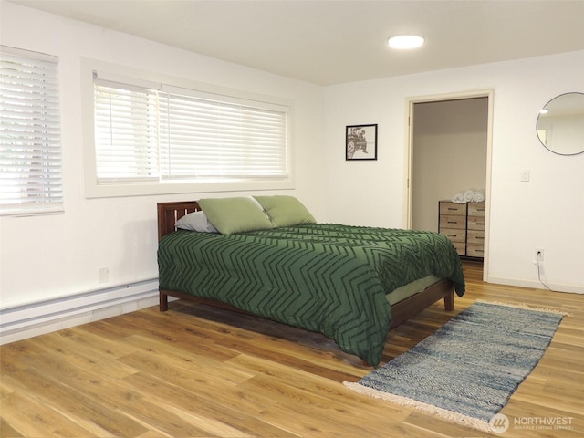 14808 131st Ave SE, Renton, WA 98058 - bedroom featuring a baseboard radiator and wood finished floors