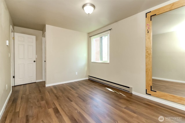 7308 N Skyview Ln Unit I-304, Tacoma, WA 98406 - unfurnished bedroom featuring a baseboard heating unit and wood finished floors
