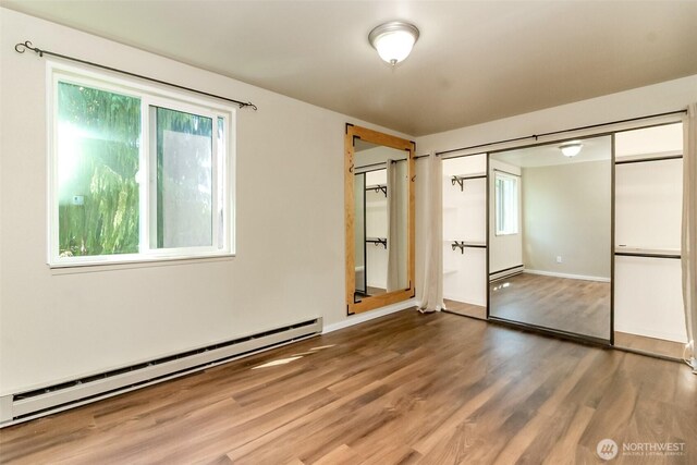7308 N Skyview Ln Unit I-304, Tacoma, WA 98406 - unfurnished room with a baseboard radiator, plenty of natural light, and wood finished floors