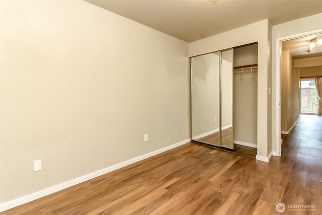 7308 N Skyview Ln Unit I-304, Tacoma, WA 98406 - unfurnished bedroom with wood finished floors and a closet