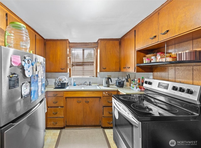 14222 4th Ave SW, Burien, WA 98166 - kitchen featuring stainless steel appliances, light countertops, and brown cabinets