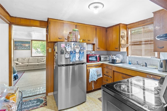 14222 4th Ave SW, Burien, WA 98166 - kitchen with freestanding refrigerator, range with electric stovetop, light floors, brown cabinets, and light countertops