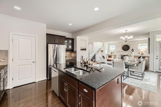 3613 198th Pl SE, Bothell, WA 98012 - kitchen with dishwashing machine, dark wood finished floors, dark stone countertops, a chandelier, and freestanding refrigerator