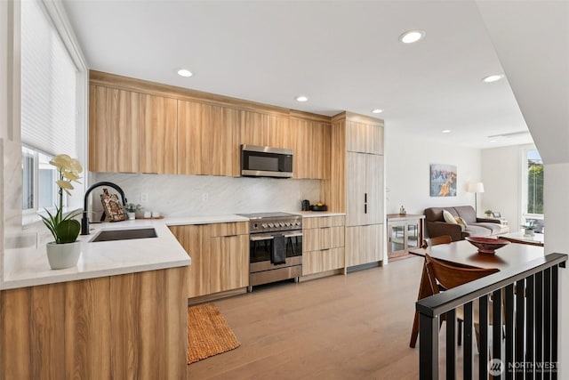 4303 Dayton Ave N Unit E, Seattle, WA 98103 - kitchen featuring stainless steel appliances, modern cabinets, light brown cabinets, light countertops, and decorative backsplash