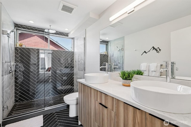 4303 Dayton Ave N Unit E, Seattle, WA 98103 - bathroom featuring double vanity, a stall shower, recessed lighting, and tile patterned flooring