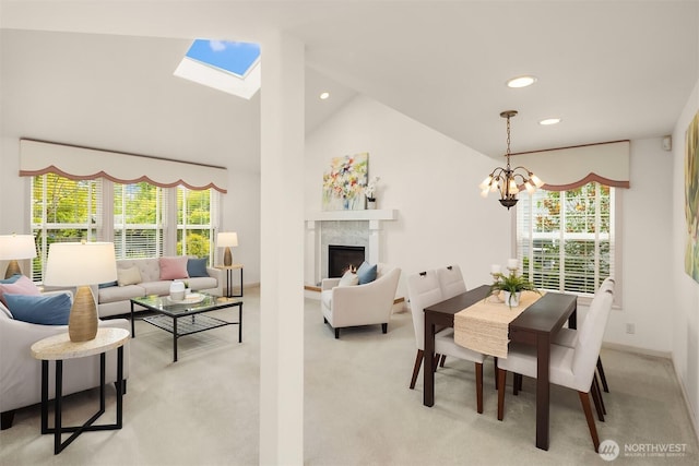 8612 218th St SW, Edmonds, WA 98026 - dining area with light carpet, a skylight, a chandelier, lofted ceiling, and a high end fireplace
