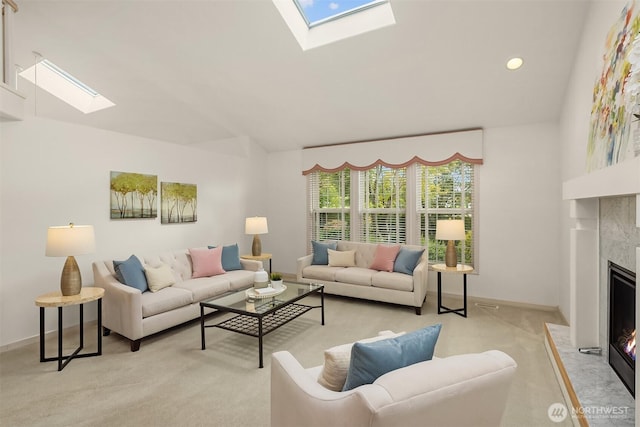 8612 218th St SW, Edmonds, WA 98026 - living room with a skylight, a fireplace, light colored carpet, vaulted ceiling, and recessed lighting