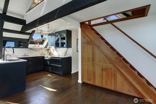 2822 Boyer Ave E Unit 11, Seattle, WA 98102 - kitchen featuring stainless steel range with electric cooktop, tasteful backsplash, glass insert cabinets, light countertops, and vaulted ceiling