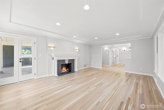 3505 W 43rd Ave, Seattle, WA 98199 - unfurnished living room featuring french doors, a high end fireplace, light wood-style flooring, recessed lighting, and ornamental molding